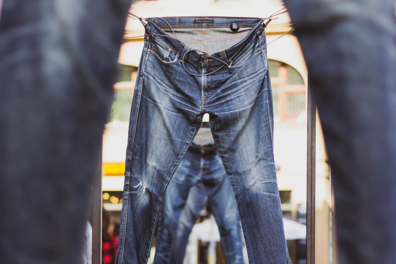 denim jeans hanging in a line.