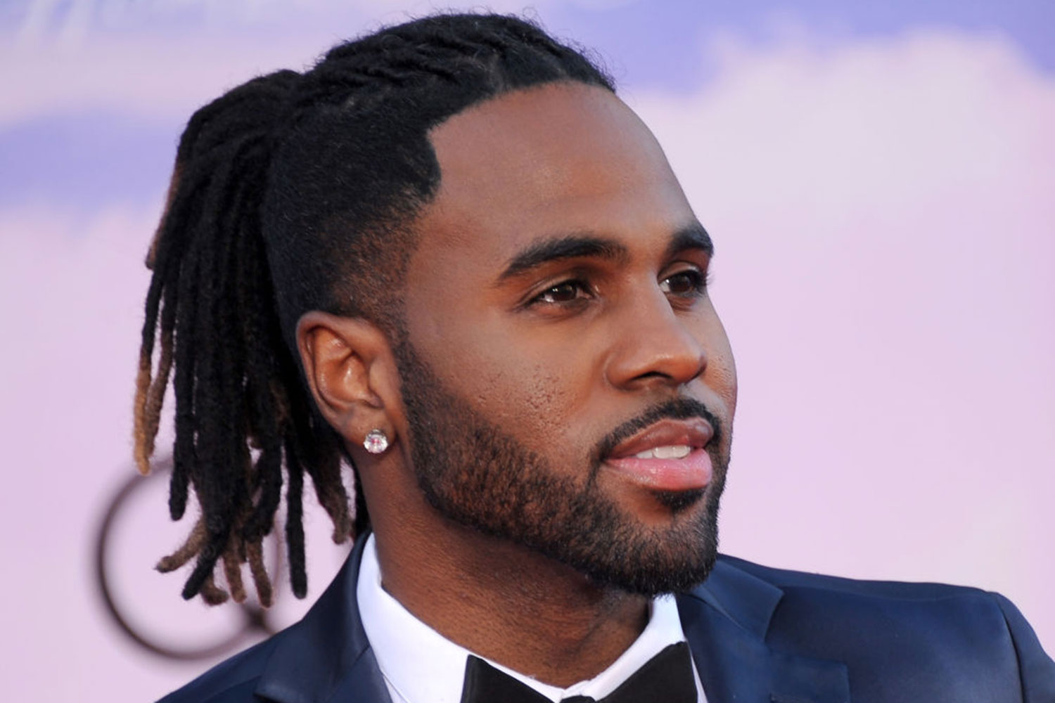 A barbershop photograph of a bearded hipster male with a braided ponytail  hairstyle and an undercut haircut imitating the Ragnar Lothbrok look - Man  Bun Hairstyle