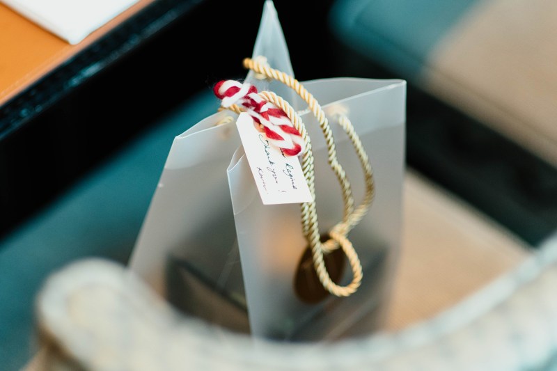 A gift bag with a tie and tag for the recipient.