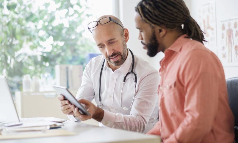 man talking to doctor diagnosis