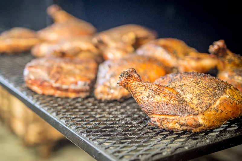 Cooked turkeys on a metal grill.