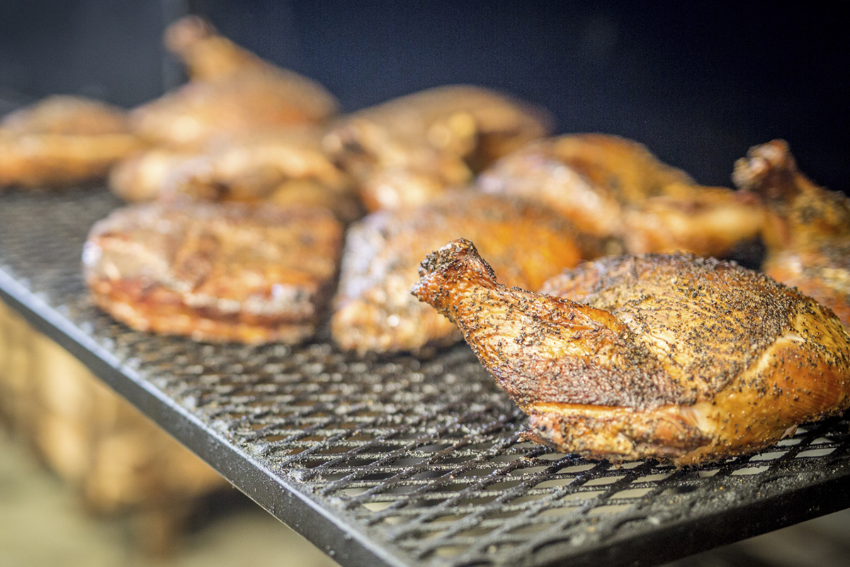 Cooked turkeys on a metal grill.