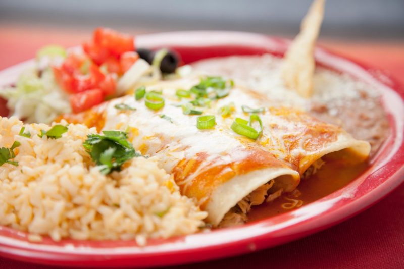 Enchiladas with rice and beans.
