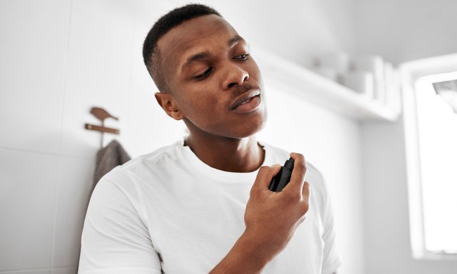 man spraying fragrance