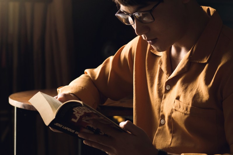 man with glasses reading