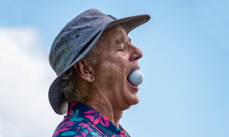 bill murray with a golf ball in mouth