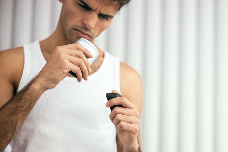Man figuring out what is better to use: deodorant or an antiperspirant?