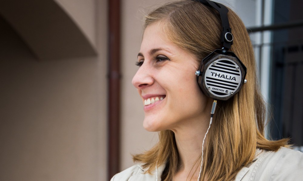 woman listening to podcast and smiling