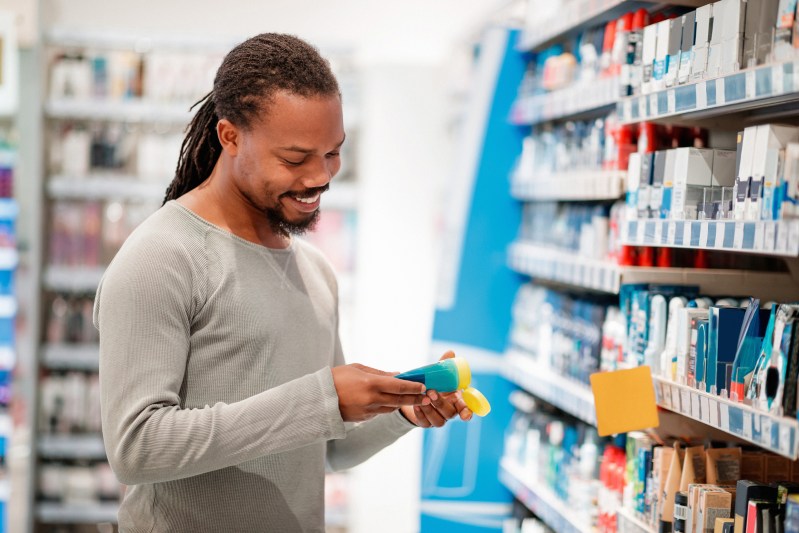 Man choosing hair product in department store.