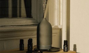 A diffuser on a table in a room.