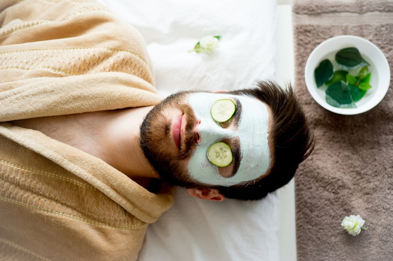 Man wearing a clay mask