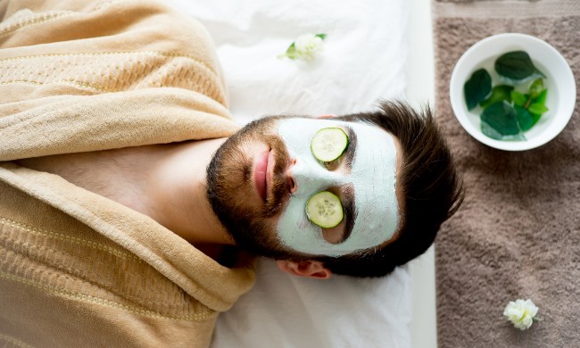 Man wearing a clay mask