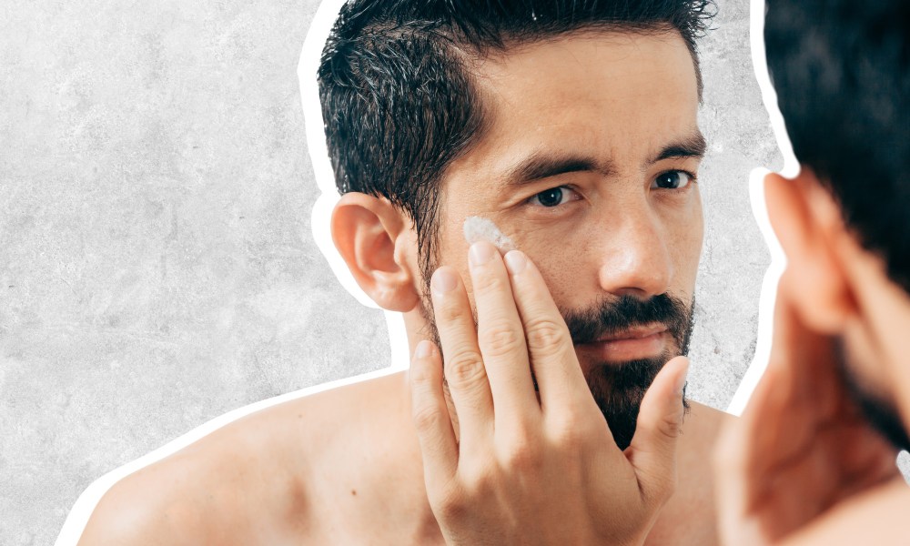 Man using face moisturizer