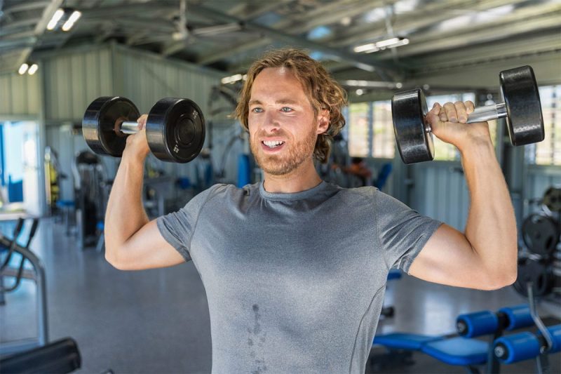 Man doing dumbbell overhead press.