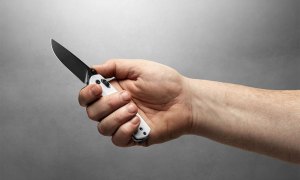 Hand holding a flipper knife