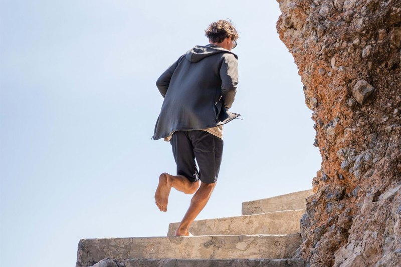 Man running on the steps barefoot.