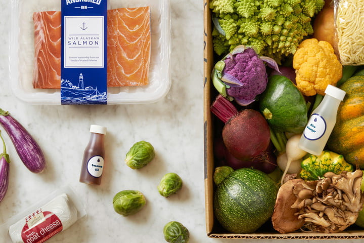 A Blue Apron meal kit showing meat, vegetables, and condiments alongside each other.