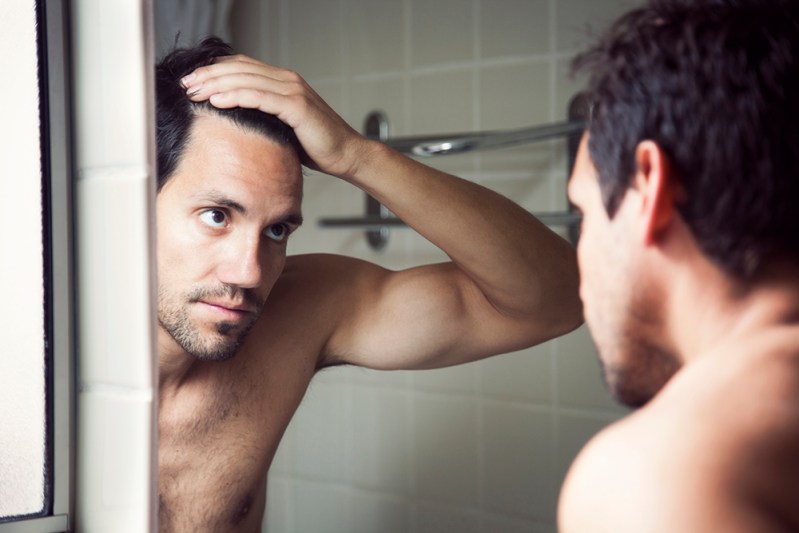 Man treating stress-related hair loss