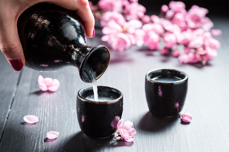 Female hand pouring sake