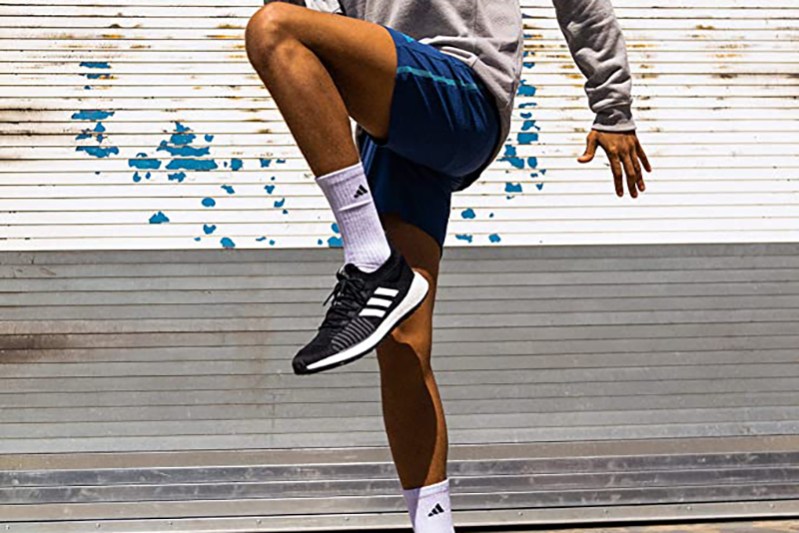 A man wearing Adidas shoes and socks.