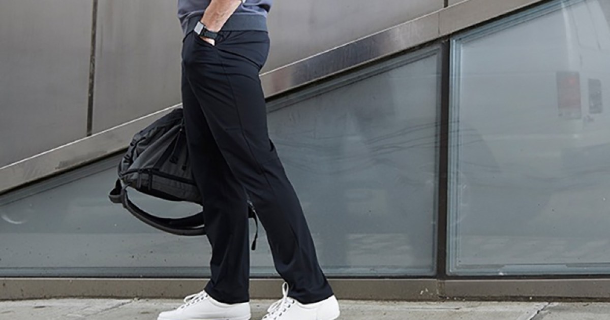 White sneakers, beige pants and black basketball jersey outfit