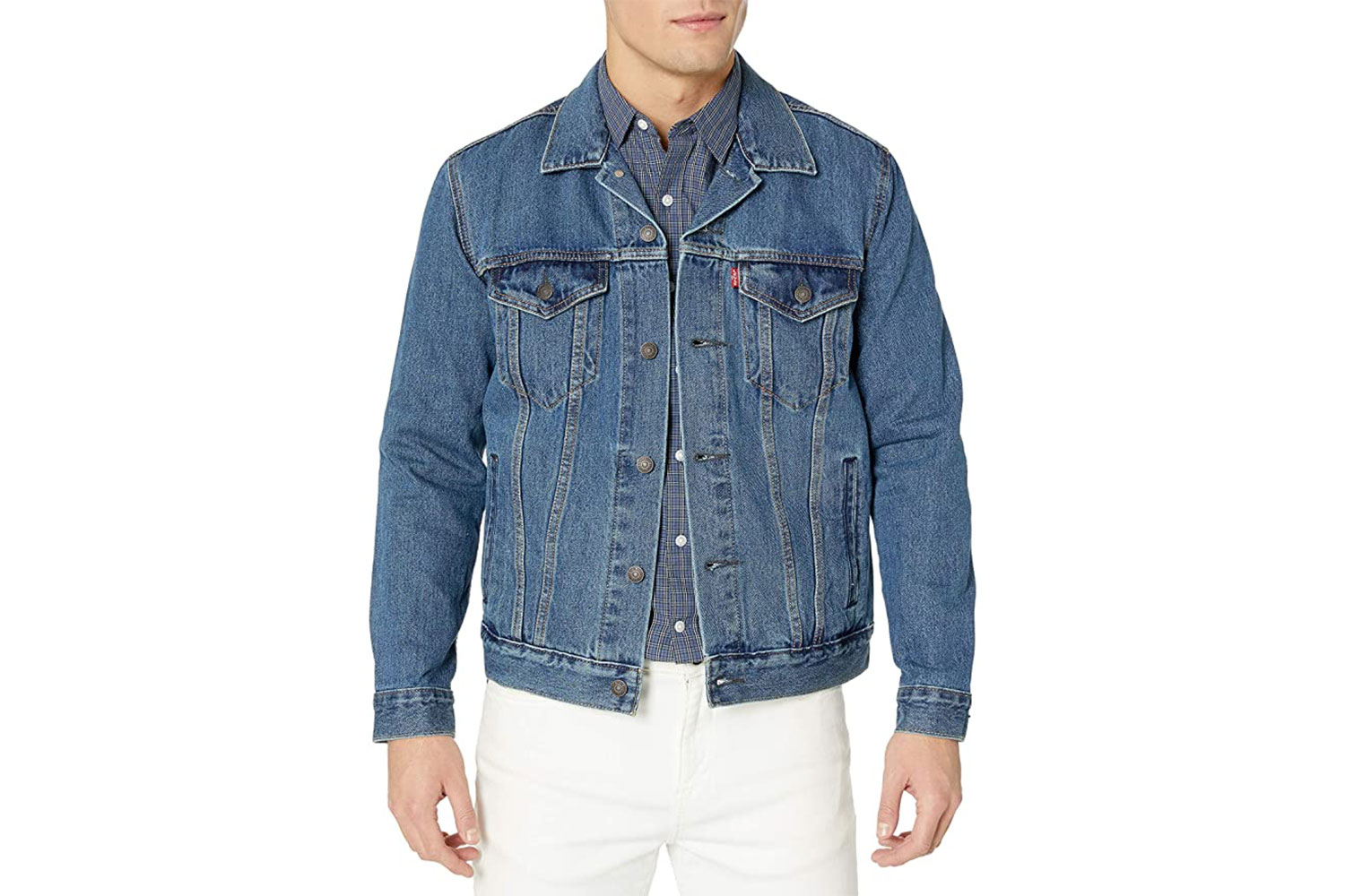 A man wearing Levi's Trucker Jacket in Medium Stonewash.