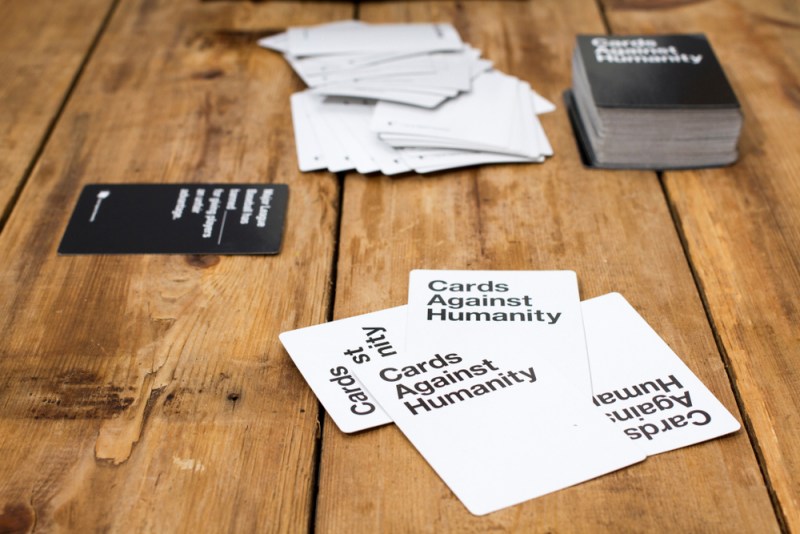 Cards Against Humanity on a wooden table.