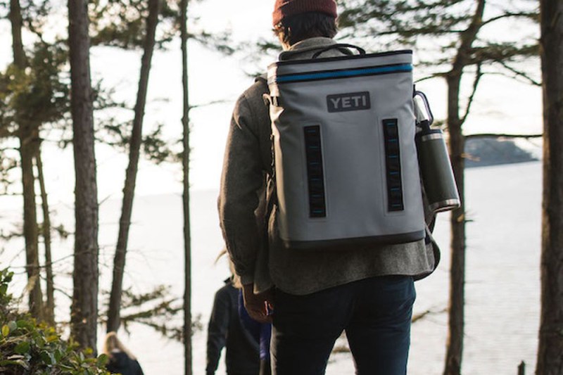 Man outdoors with a Yeti bag.
