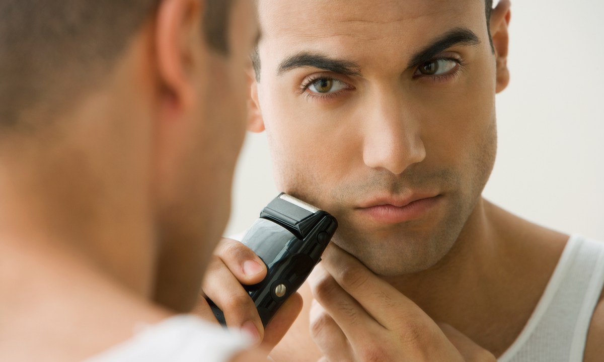 A man shaving in the mirror
