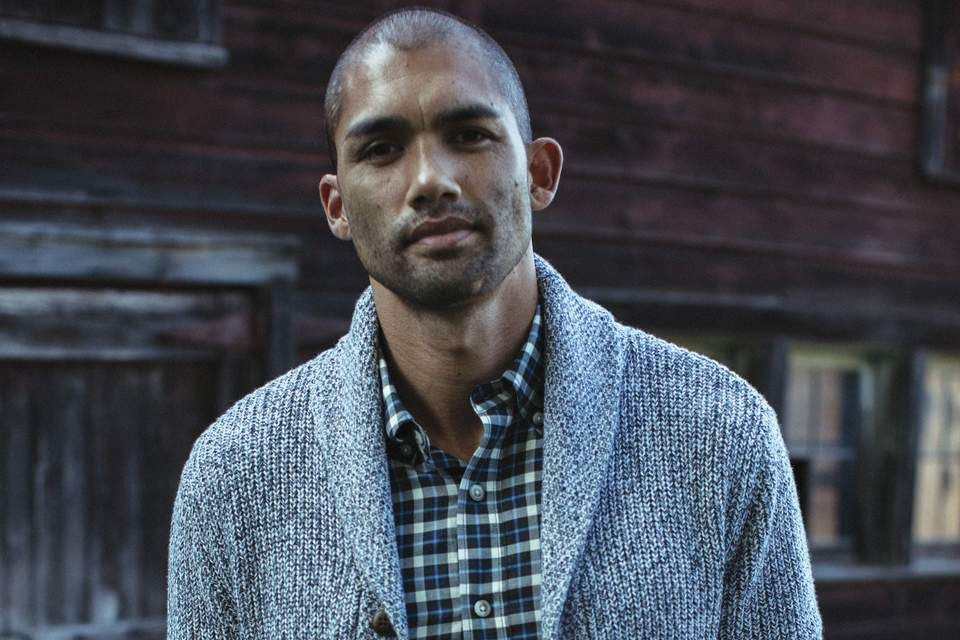 Man in a plaid shirt and cardigan