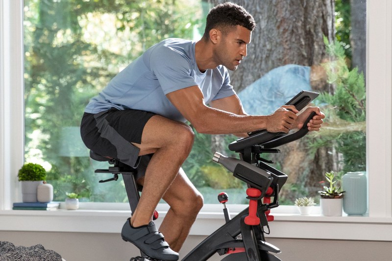A man doing cardio exercise with his indoor bike.