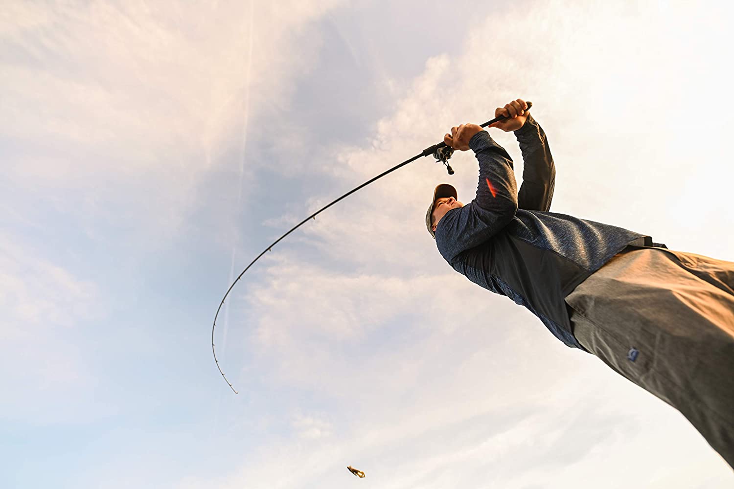 Low-angle view of a man casting a St. Croix Rods Legend Xtreme Casting Rod against the sky.
