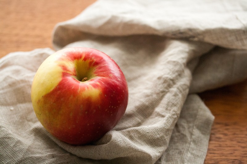 A Sweetango Apple placed on a piece of cloth.