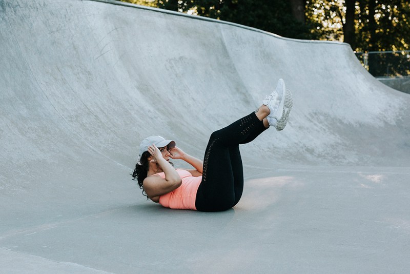 Woman doing double crunches.