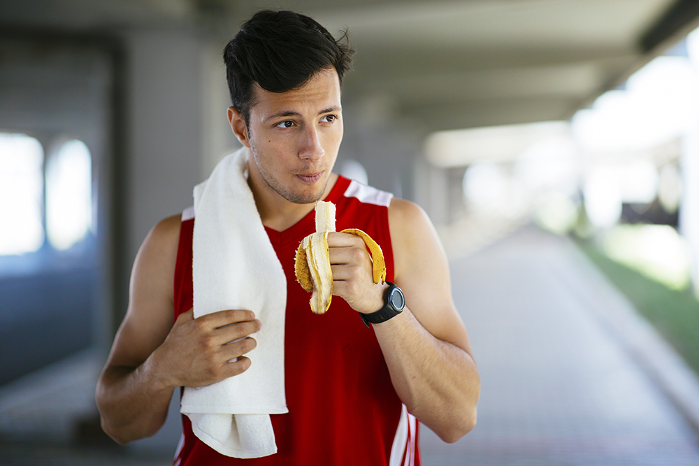 Man eating a banana before a run