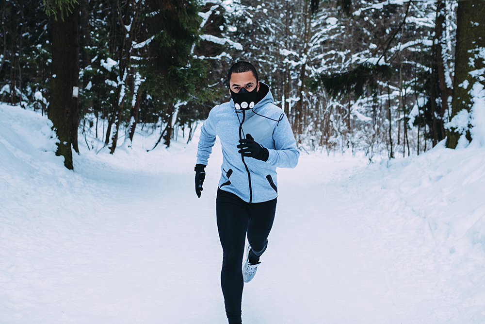 Man running on snow-covered field