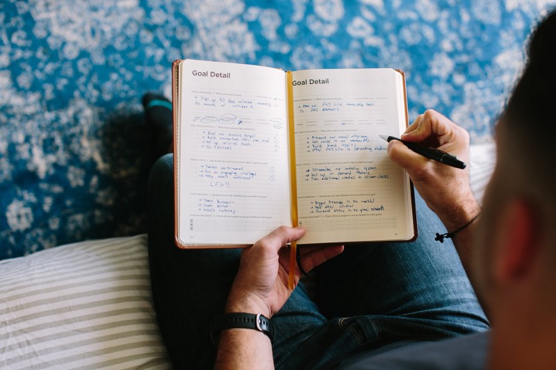 Person writing in their planner