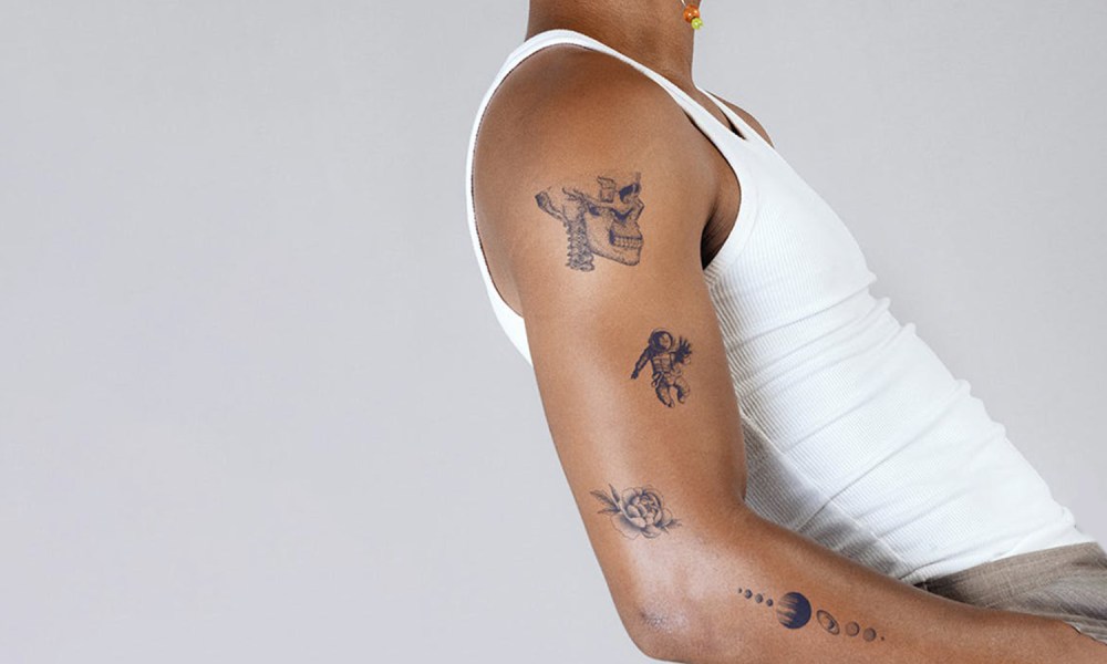 A man with some arm tattoos.