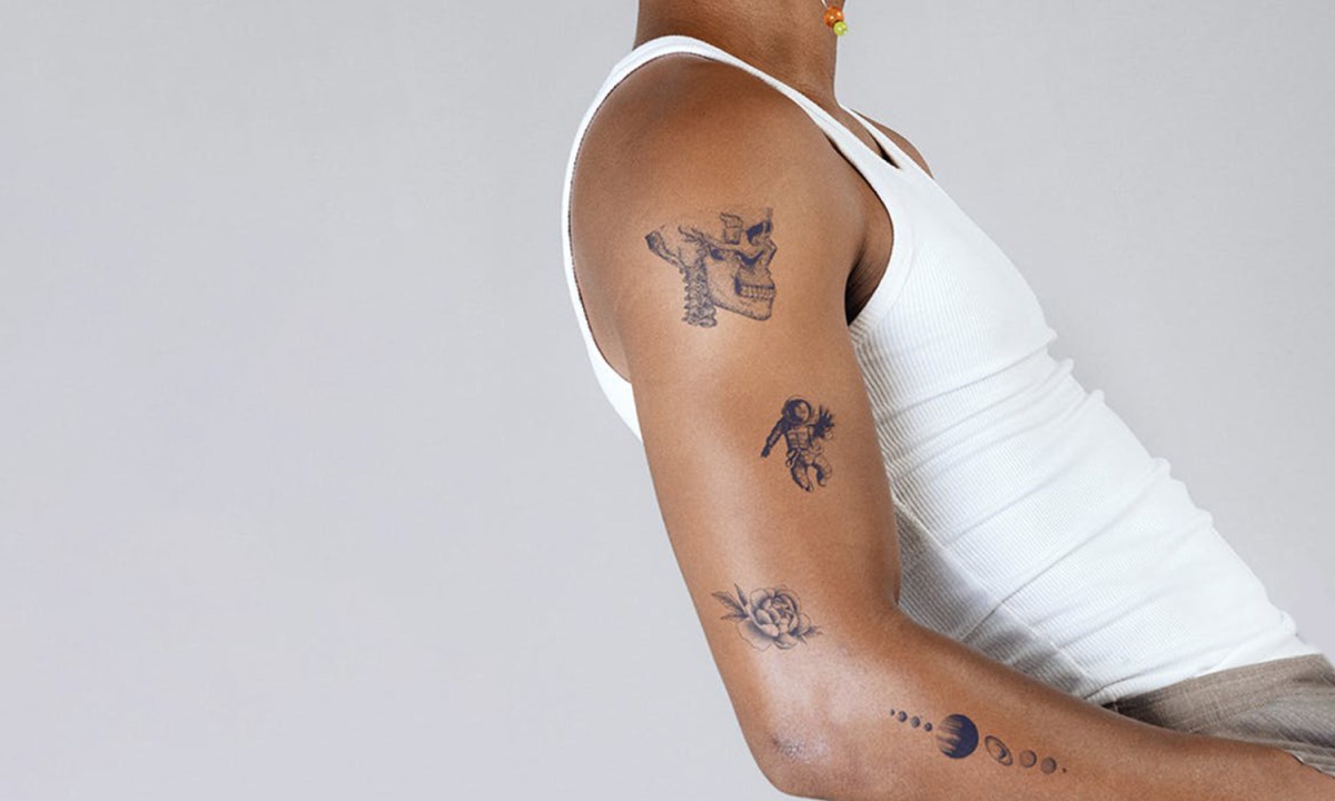A man with some arm tattoos.