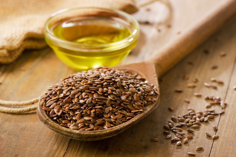 Flaxseeds in a spoon with oil