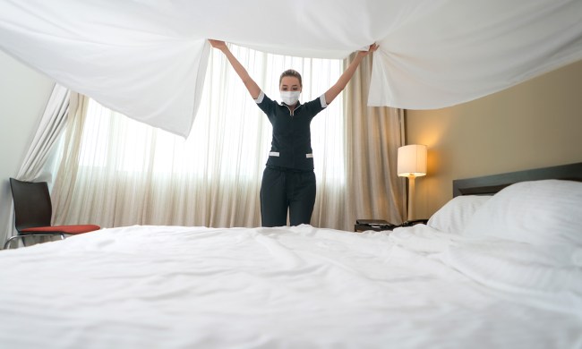 Hotel staff changing sheets.