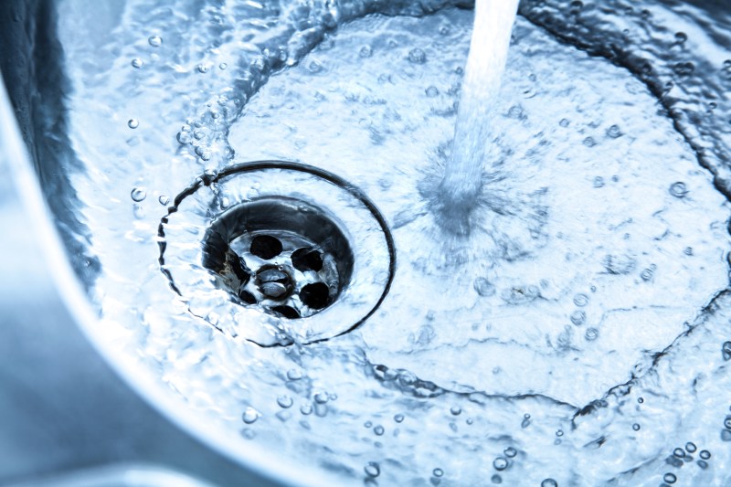 Stainless steel kitchen sink with running water