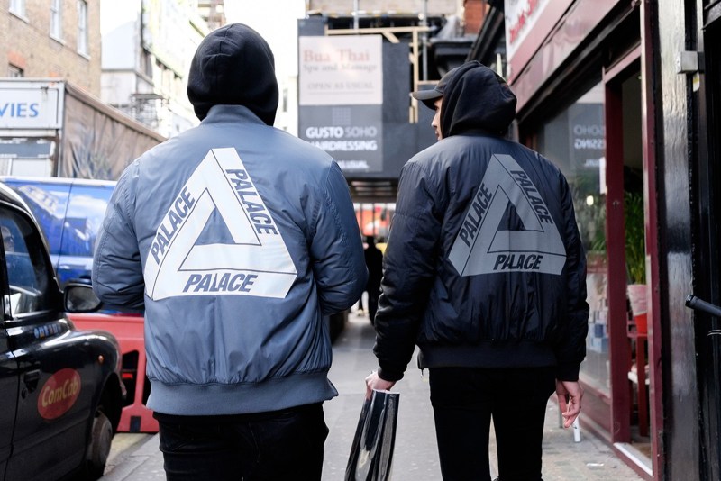 Two men wearing Palace jackets on the street