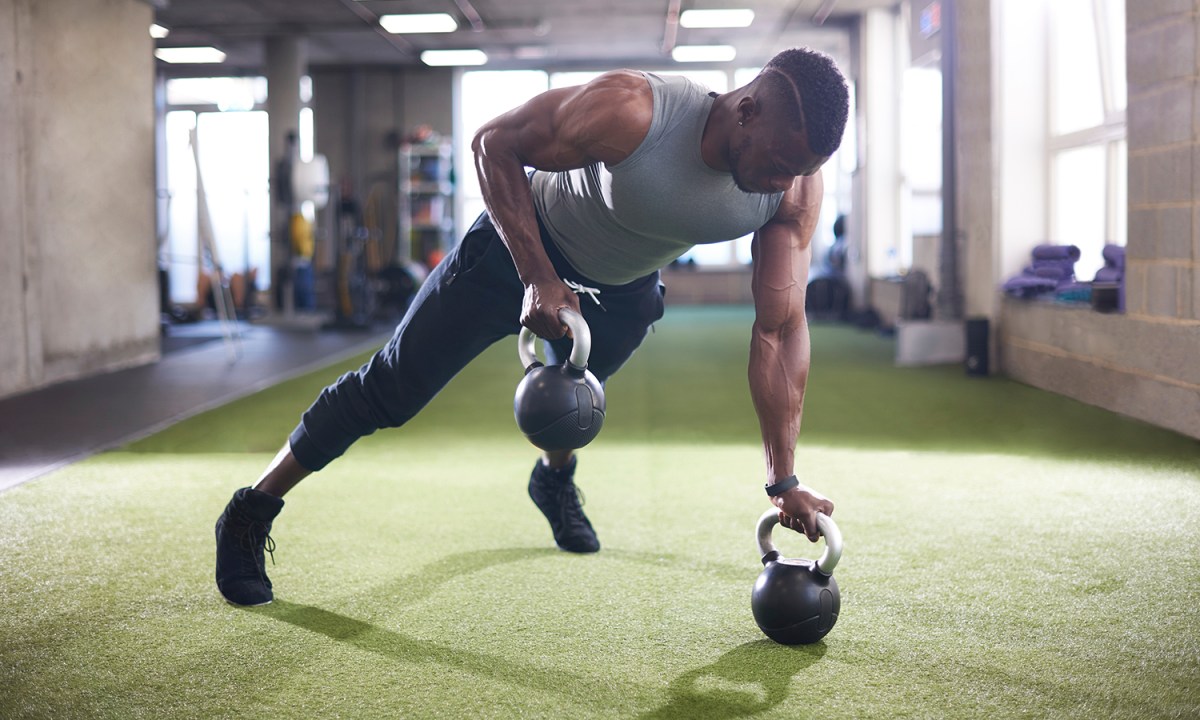 Man using kettlebells.
