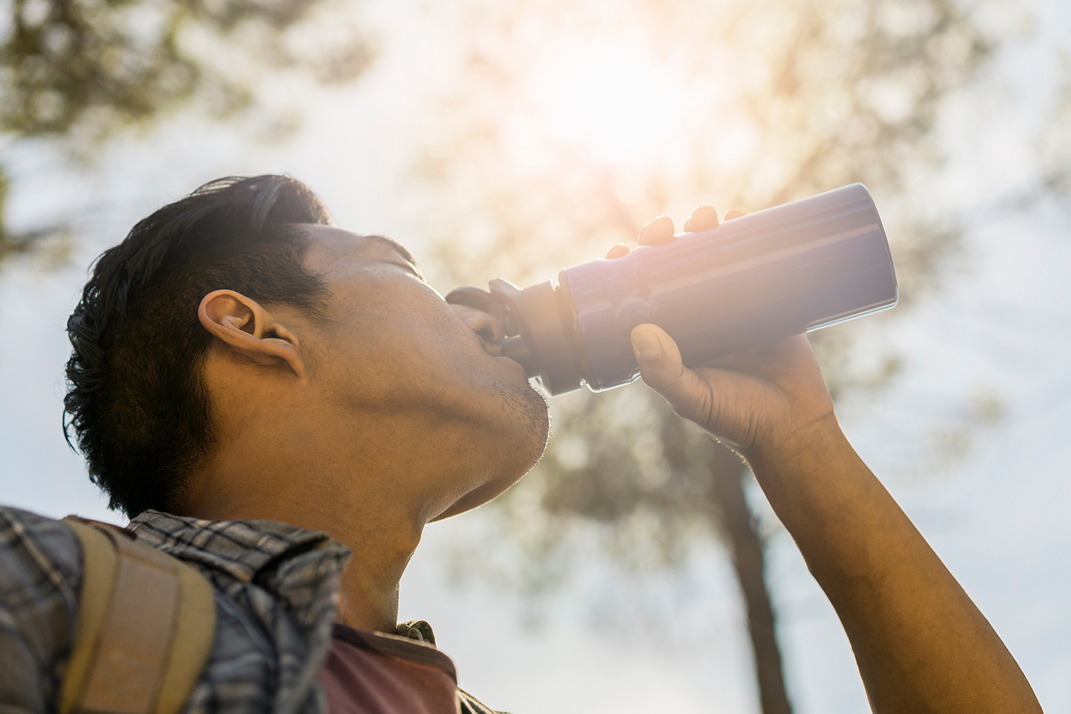 man drinking from a water bottle. 