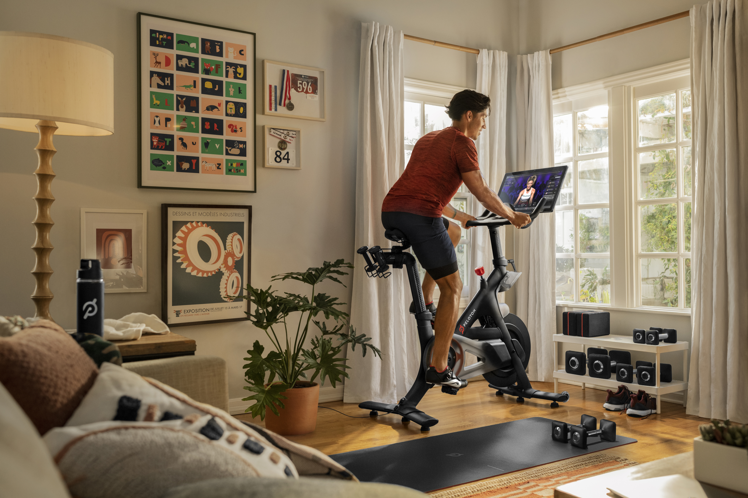 Cyclist on a Peloton in living room.