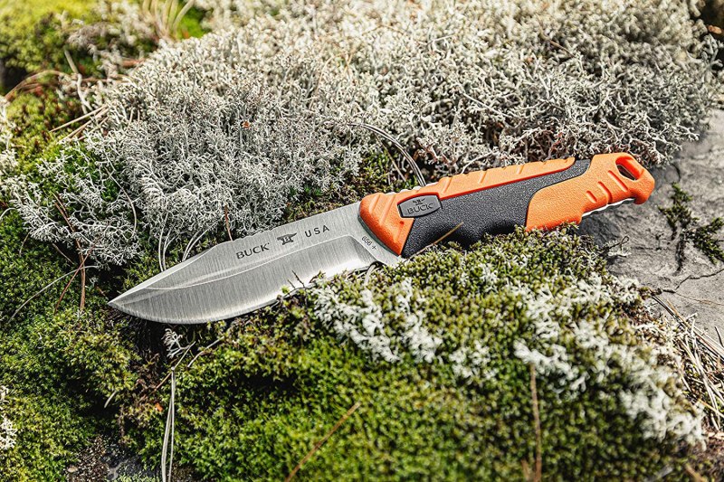 Buck 656 Pursuit Pro Hunting Knife on a rock in the woods.