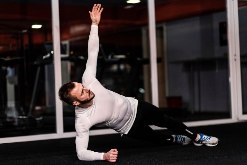 man doing side plank