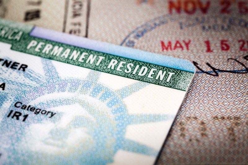A person's Green Card sitting on a table.