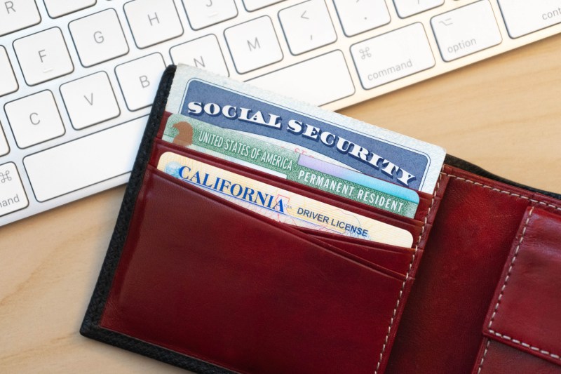 A social security card sticking out of a wallet.
